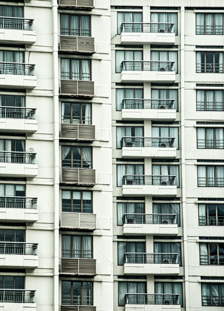 Detailed view of a modern condominium building with balconies in Jakarta, Indonesia.